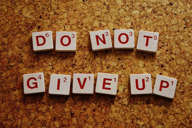 Improving your motivation - Scrabble letters spell out Do not give up