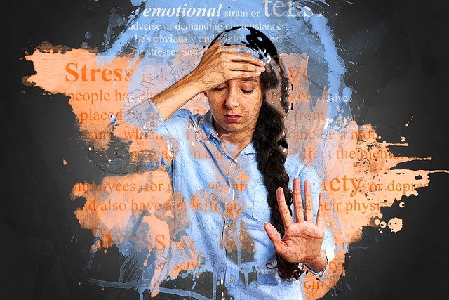 Freeing yourself from anxiety - woman holding her head, stressed dictionary definitions of stress and anxiety in background