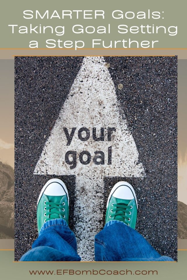 SMARTER Goals: Taking Goal Setting a Step Further - looking down at a person's feet on the street in front of a white arrow that says your goal