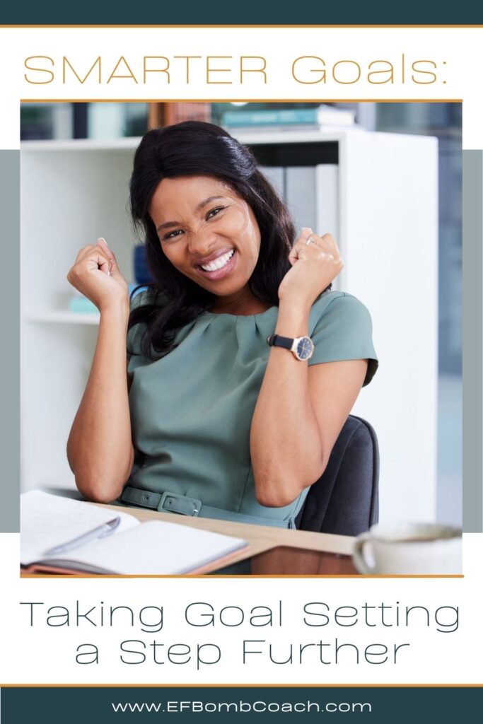 SMARTER Goals: Taking Goal Setting a Step Further a black woman with a smile and arms raised in a cheer