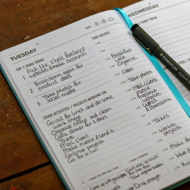 a notebook with a pen on top of it - overpacked schedule